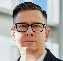 Alexander Hughes executive portrait leading cryptocurrency trading platform